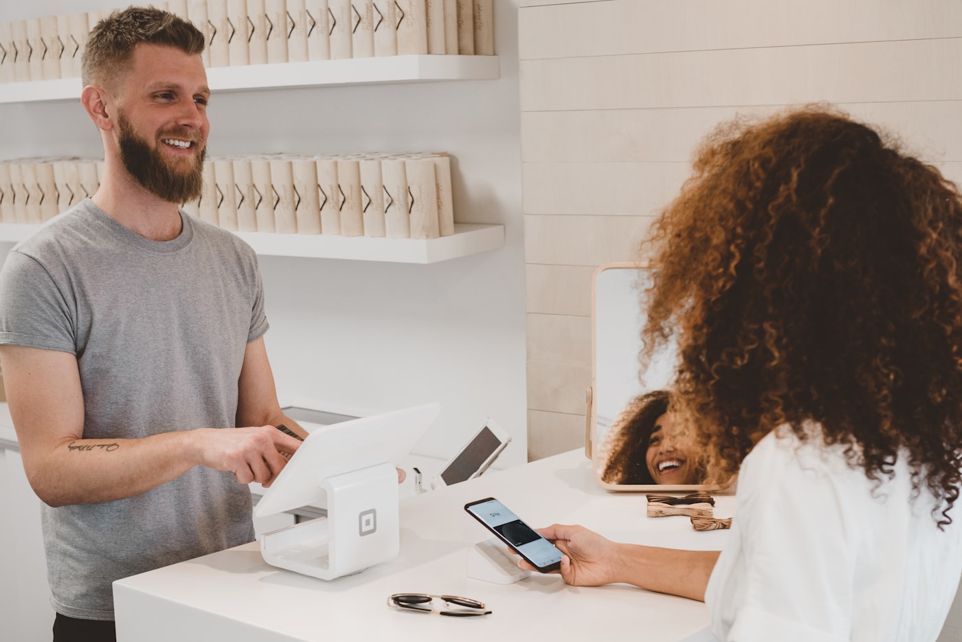 Merchant taking a card payment at a modern point-of-sale terminal